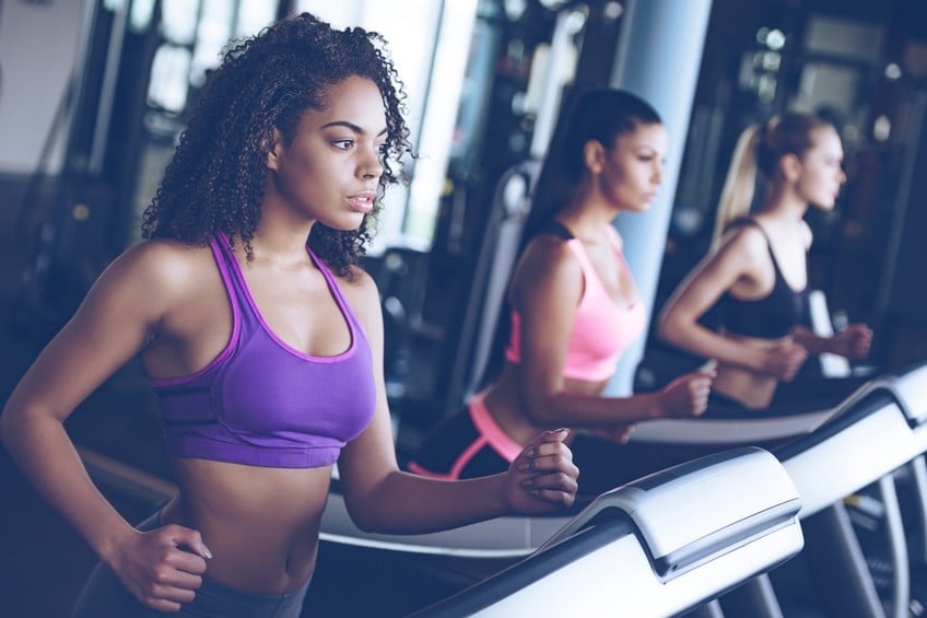women looking away while running on treadmill