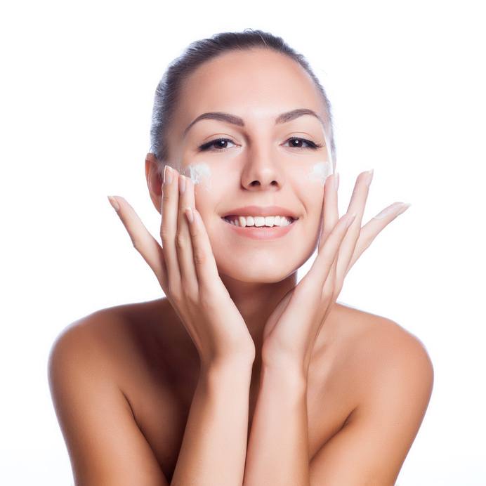 beautiful model applying cosmetic cream
