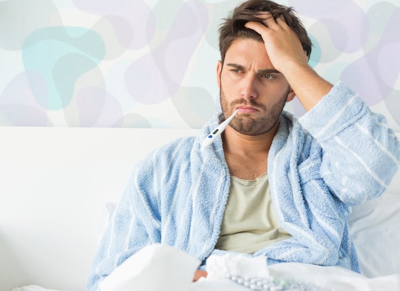 Sick man with thermometer in mouth