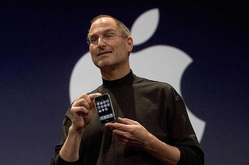 Apple CEO Steve Jobs holds up the new iPhone