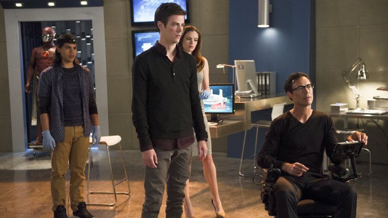 Four people in a room with computers
