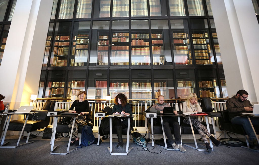 Visitors study and use their laptops at The British Library