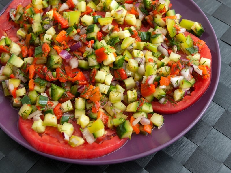 Tomatoes with salsa salad made of cucumbers