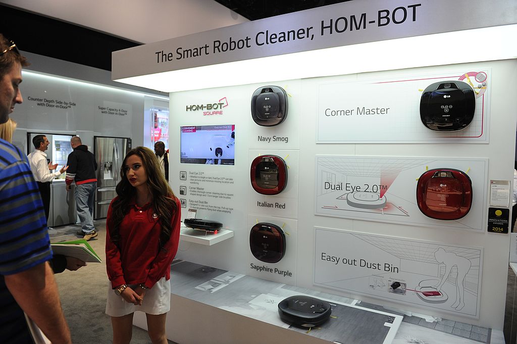 Attendees look at a vacuum cleaner robots