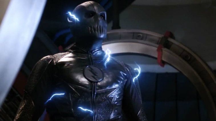 A gray costumed character with a lightning bolt symbol on its chest