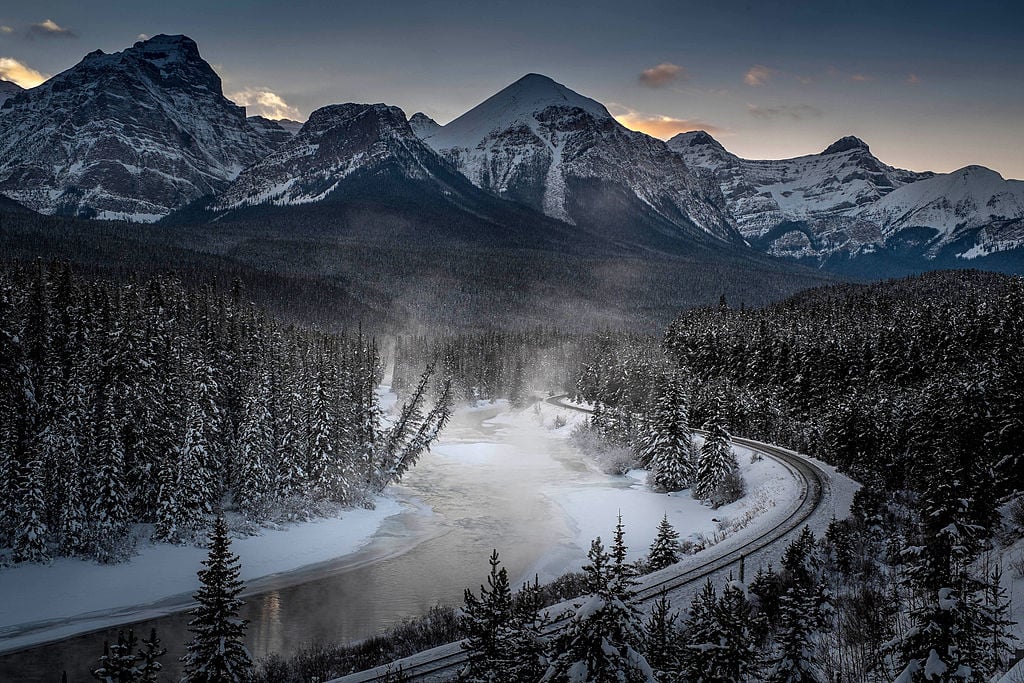 A view of the famous 'Morant's Curve' offering a beautiful view of the frozen Bow River and the Canadian Pacific Railway at Banff National park