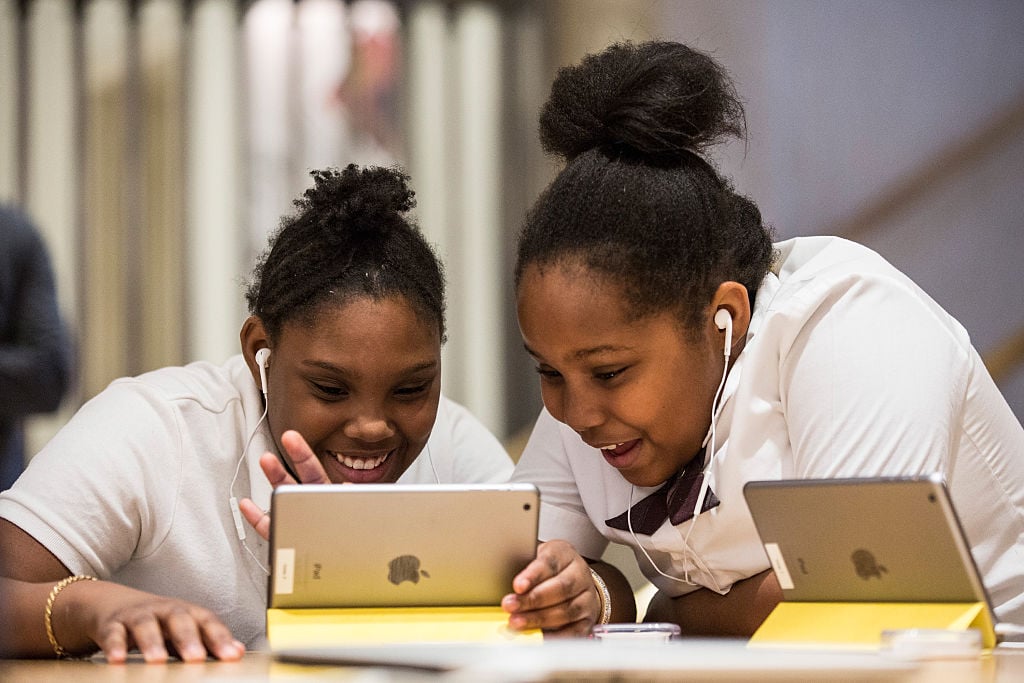 two girls learning to code