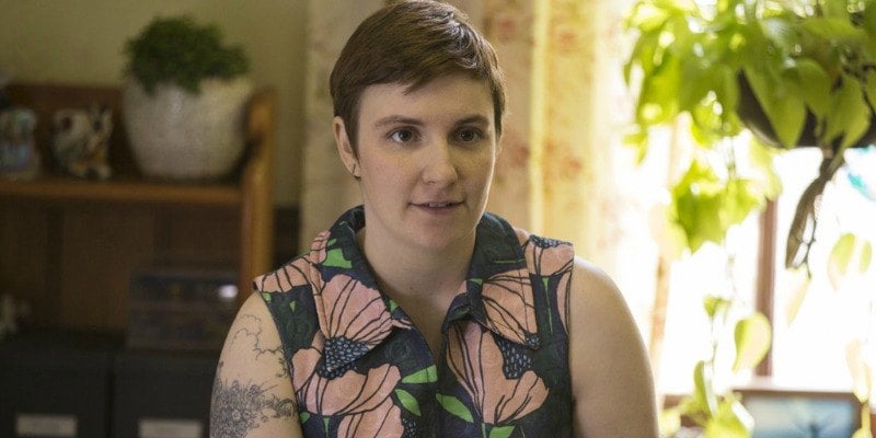 Lena Dunham as Hannah Horvath in a sleeveless floral shirt in a living room on Girls