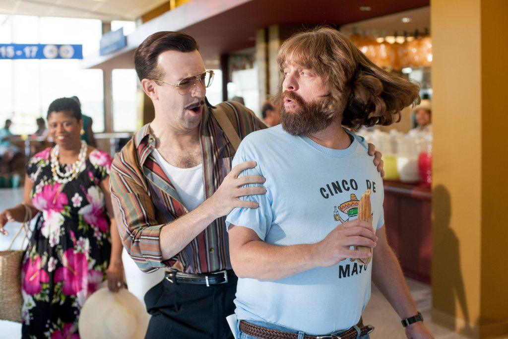 Jason Sudeikis holds onto the shoulders of Zach Galifanikis in a scene from Masterminds