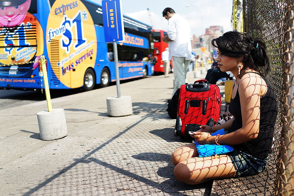 A woman waits to board a Megabus in New York City