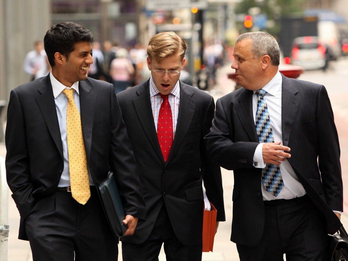 three men walking down the street in suits three men walking down the street in suits