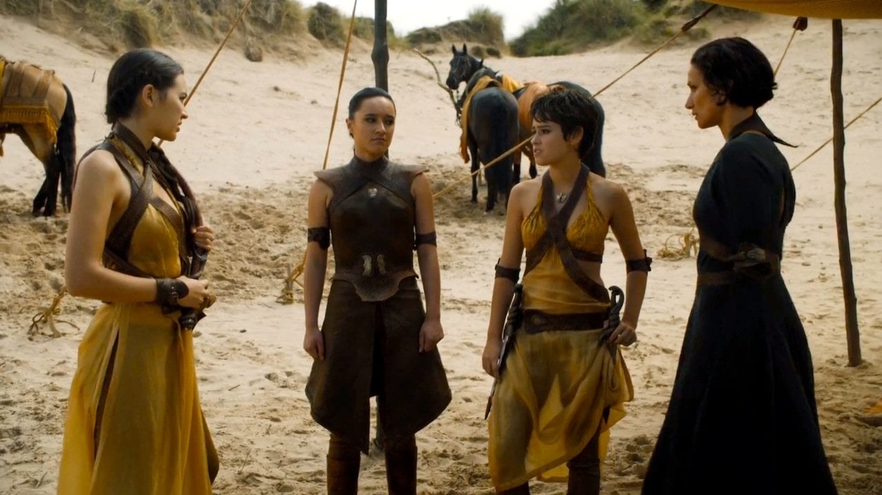 The Sand Snakes standing in a circle outside