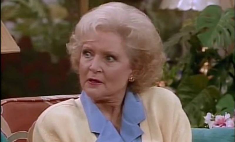 Betty White sitting a couch and talking in 'The Golden Girls'.