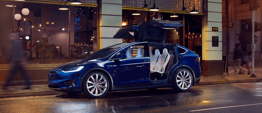 blue 2017 Tesla Model X on city street