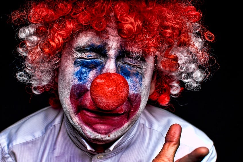 close up of a sad , upset , crying clown