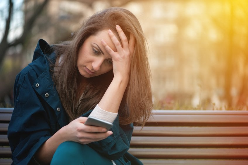 Worried girl looking at the phone