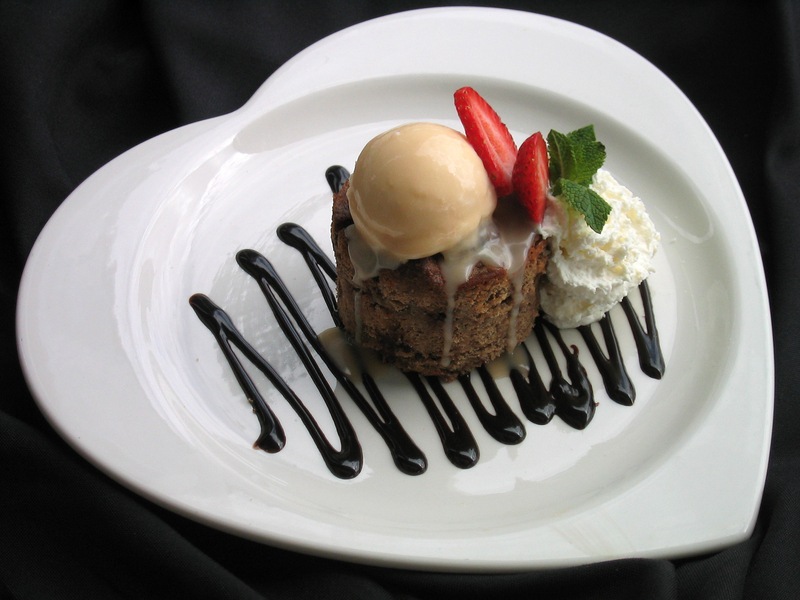 Chocolate Banana Bread Pudding in white heart shaped plate