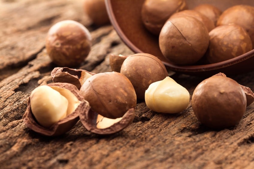 macadamia nuts on wooden plate