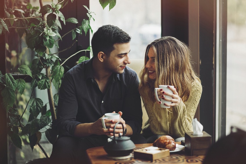 Couple in love drinking coffee and have fun in coffee shop