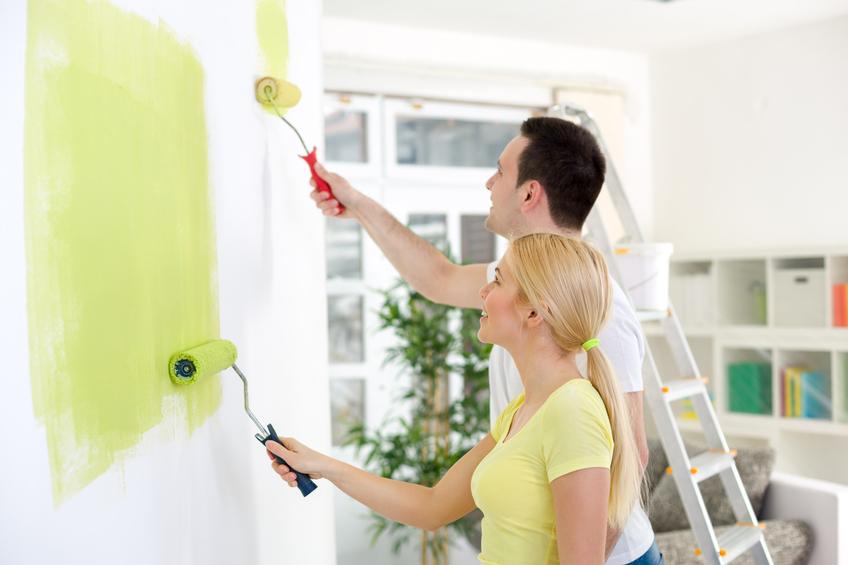 couple painting together a room in their new house