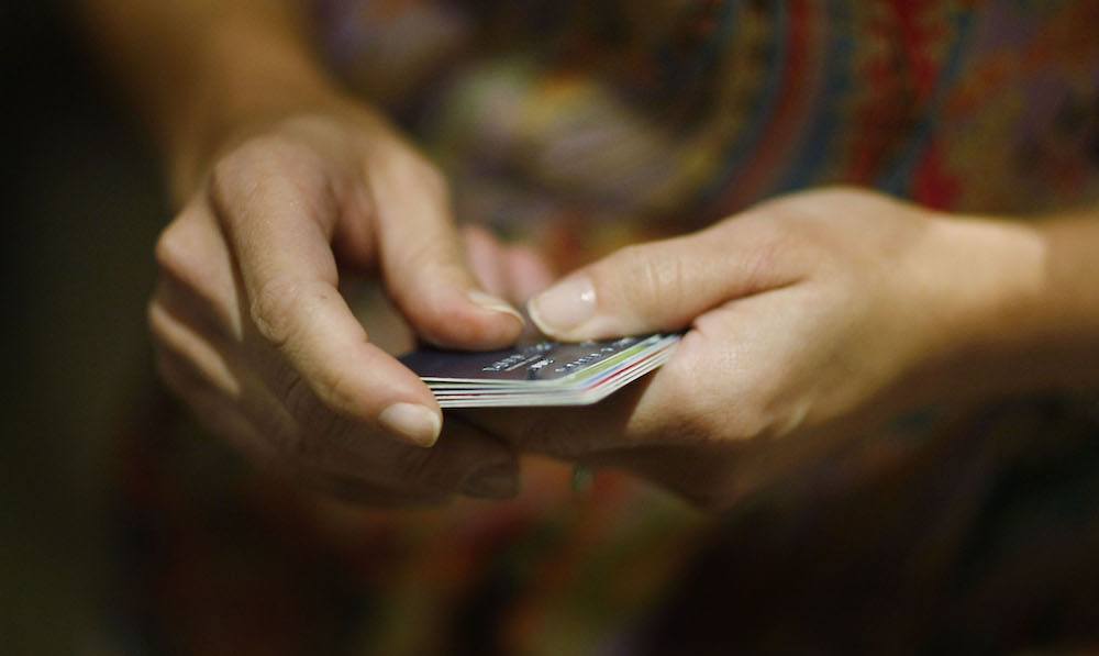 woman holding credit cards