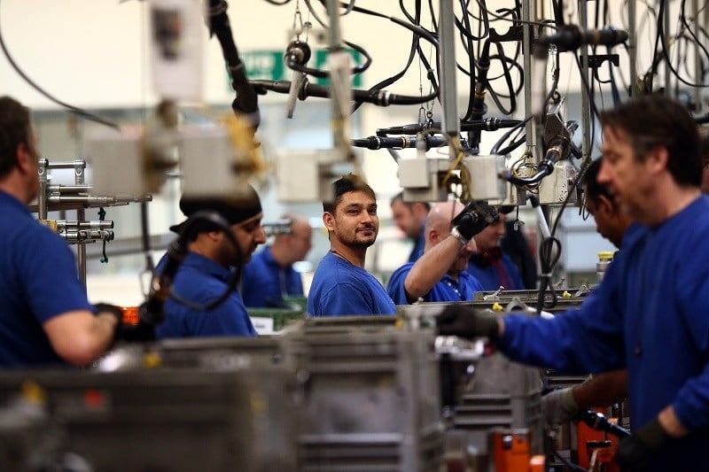 Manufacturing workers at their jobs in an assembly plant