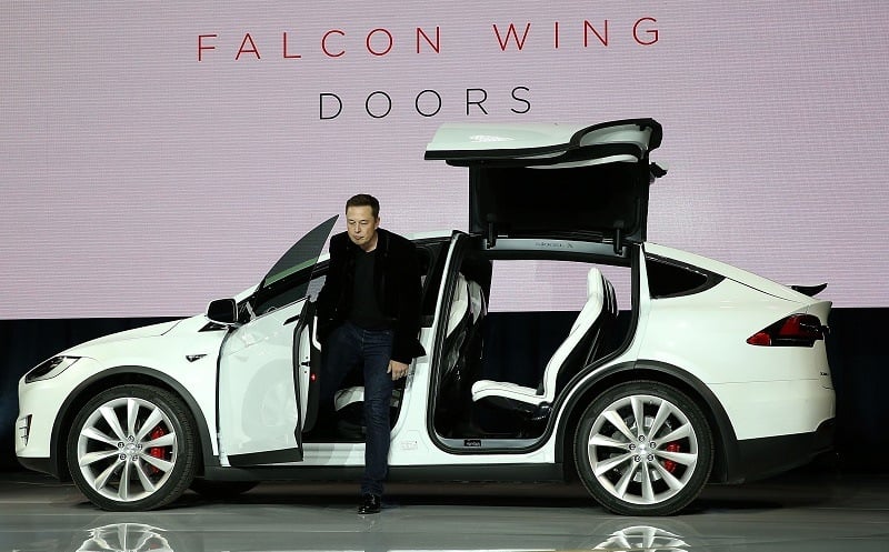 FREMONT, CA - SEPTEMBER 29: Tesla CEO Elon Musk demonstrates the falcon wing doors on the new Tesla Model X Crossover SUV during a launch event on September 29, 2015 in Fremont, California. After several production delays, Elon Musk officially launched the much anticipated Tesla Model X Crossover SUV.
