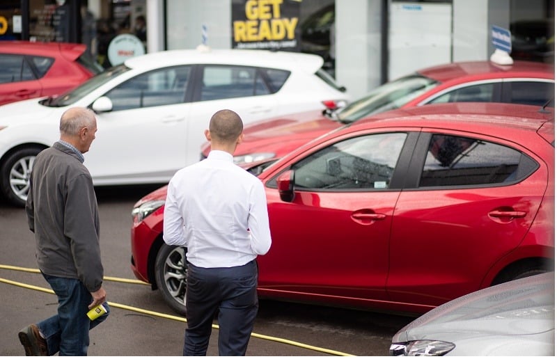 BRISTOL, ENGLAND - OCTOBER 06: A customer looks at a brand new Mazda car that is offered for sale on the forecourt of a main motor car dealer in Brislington on October 6, 2015 in Bristol, England. Latest data from the Society of Motor Manufacturers and Traders (SMMT) show a record 462,517 new cars were registered in the UK last month, a 8.6% year on year increase, and that total sales in the year to date have hit 2,096,886, 7.1 percent higher than the same point last year and the first time the two million mark has been passed in September since 2004. The figures also showed a slight drop in the levels of drivers choosing diesel-engined cars, claimed in part to be due to the scandal that has surrounded Volkswagen and the disclosure that they cheated emissions tests on their diesel cars.