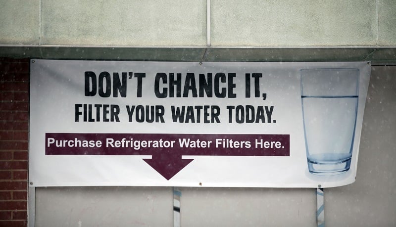 A sign on the front of a building warns residents to filter their drinking water in Flint, Michigan