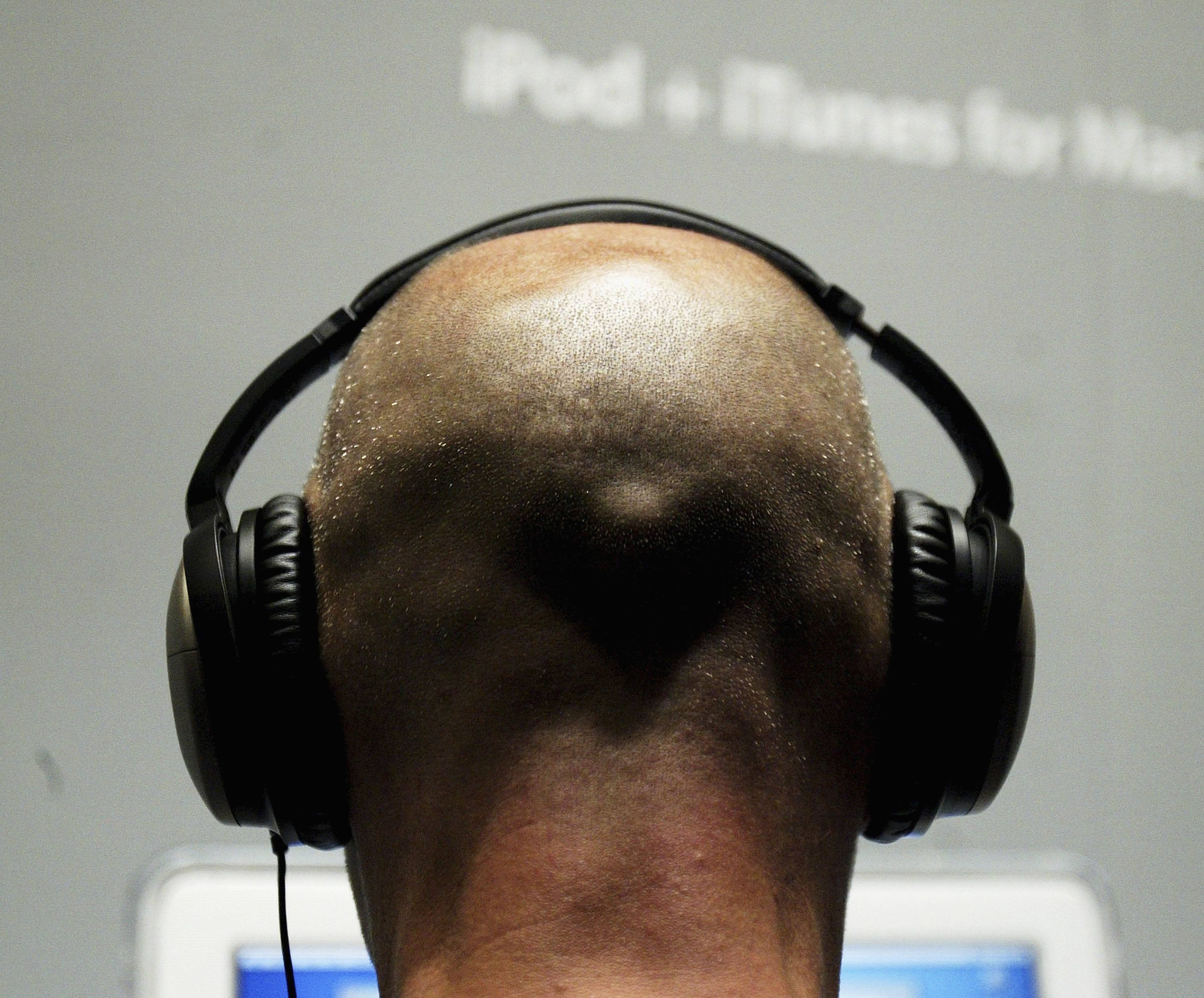 A man listens to music with headphones