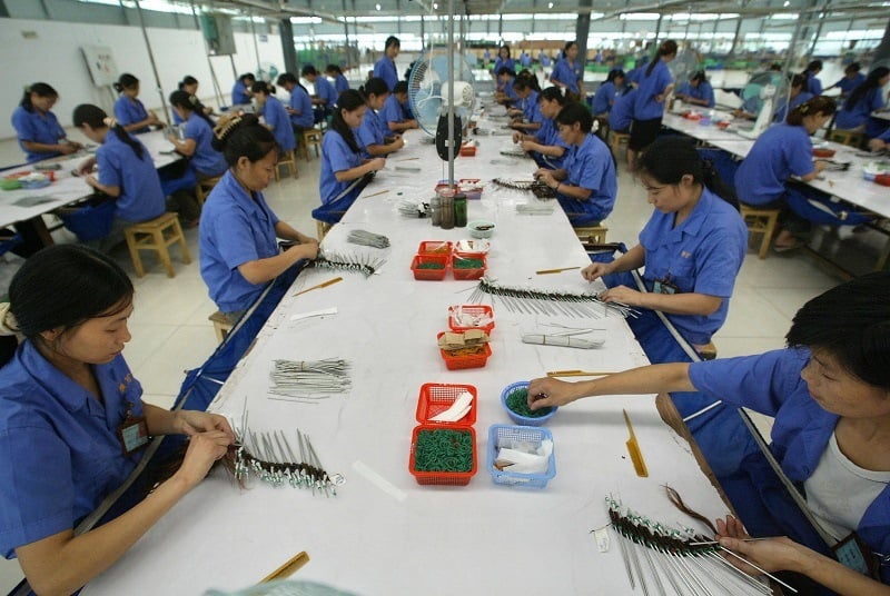 Workers assemble goods at a Hong Kong-China joint-venture factory