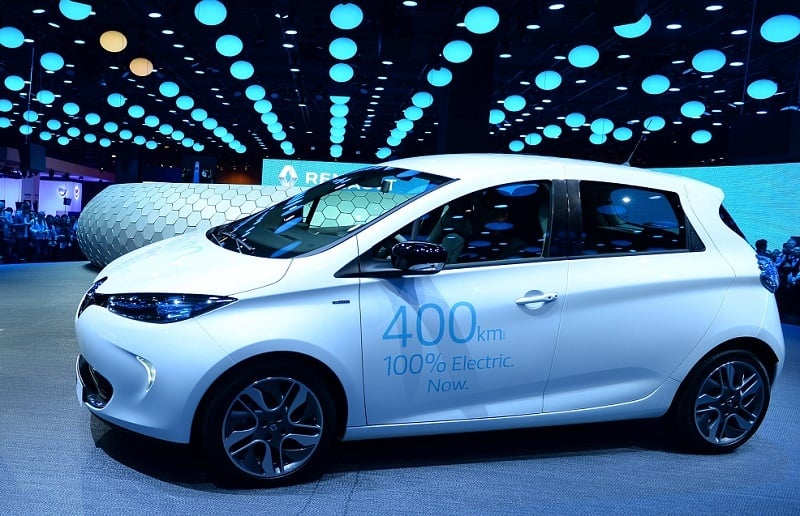 French carmaker Renault CEO Carlos Ghosn talks in front of an electric car Zoe at press days of the Paris motor Show on September 29, 2016.