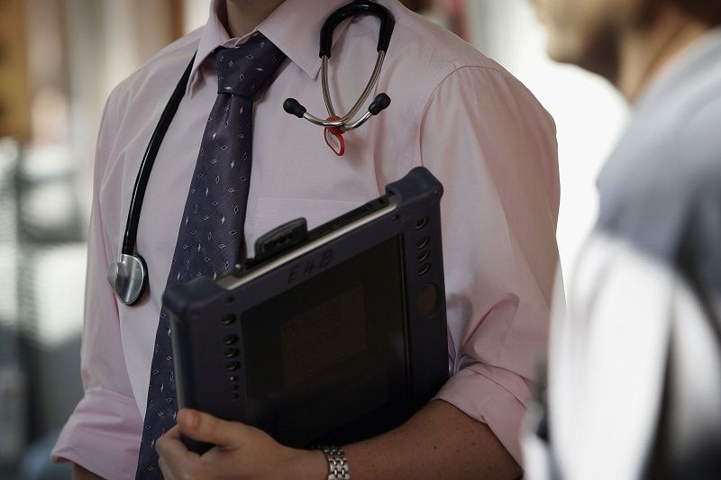 A doctor at The Queen Elizabeth Hospital Birmingham does his rounds on the wards
