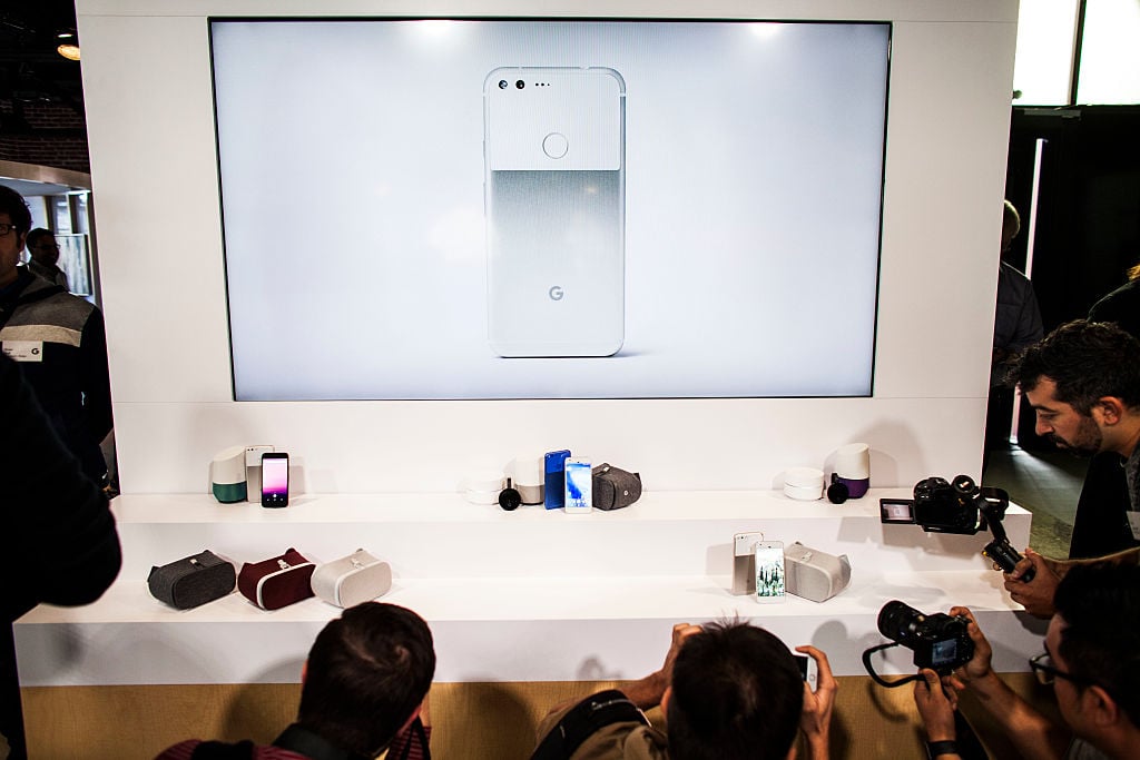 Members of the media photograph a display of Google's Pixel phone