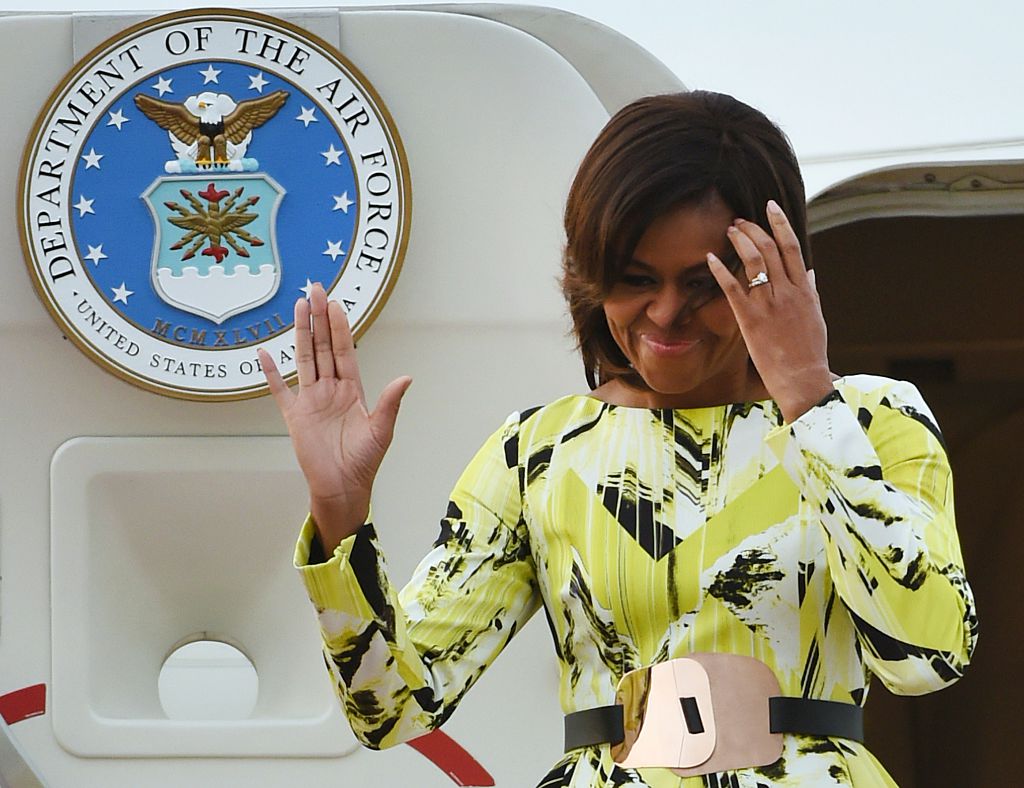 US First Lady Michelle Obama waves upon her arrival at Haneda International Airport in Tokyo