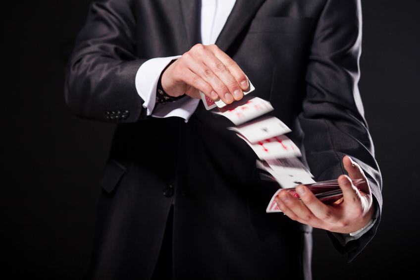 magician showing tricks using cards