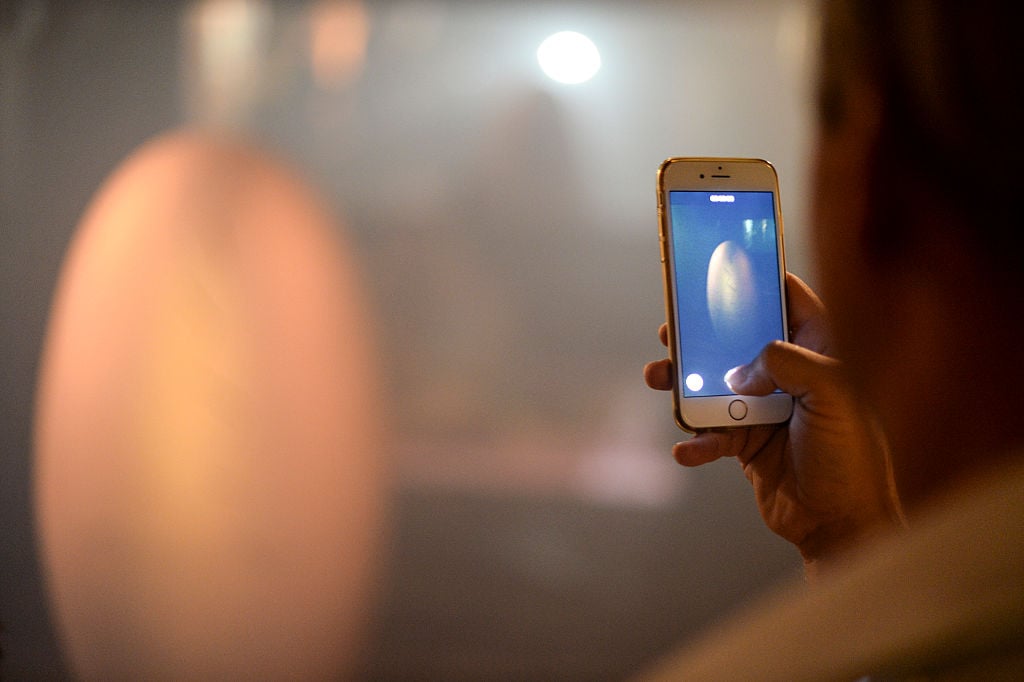 A guest using Iphone to take a photo