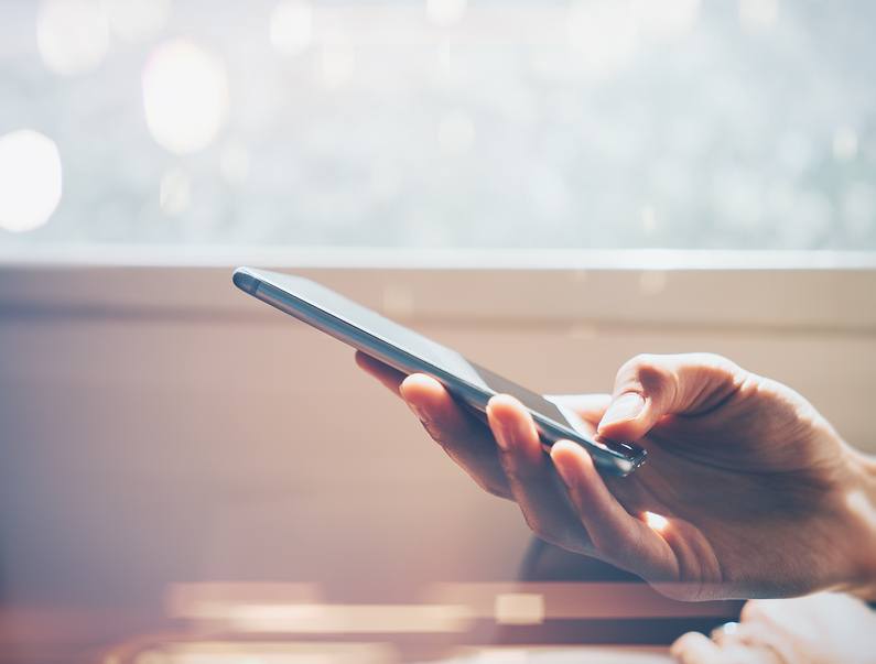 man's hand using smartphone