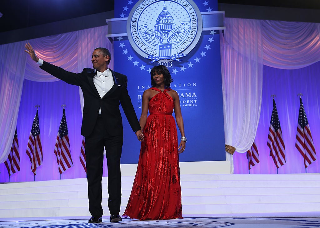 U.S. President Barack Obama and first lady Michelle Obama wave to the crowd