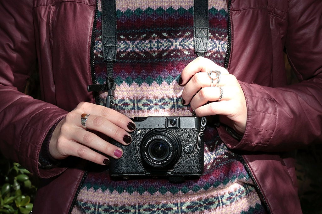 Marta is wearing a Gerry jacket Fujifilm digital camera at the Palo Alto Market