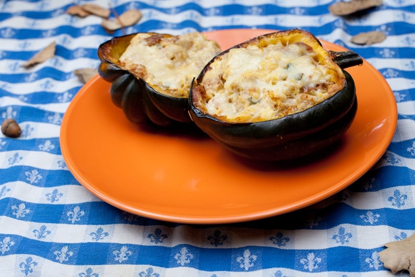 Stuffed acorn squash on an orange plate