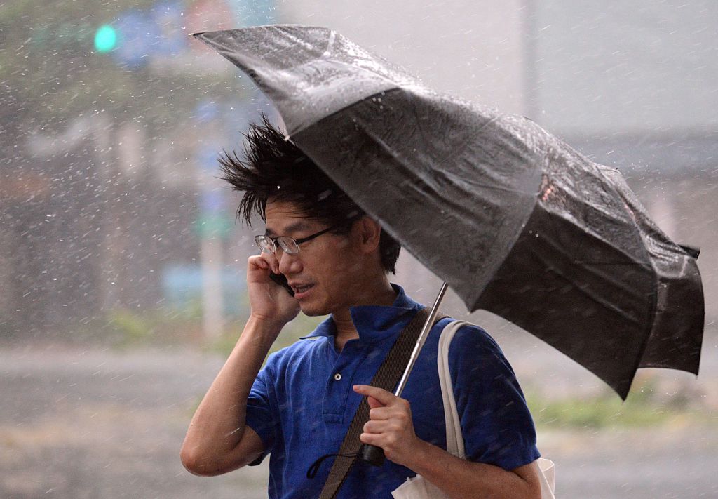 A man speaks on the phone as typhoon Soudelor hits Taipei
