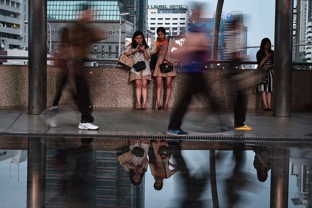 people on their mobile phones in the central business district of Bangkok