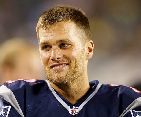 Tom Brady smiling while in uniform. Tom Brady smiling while in uniform.