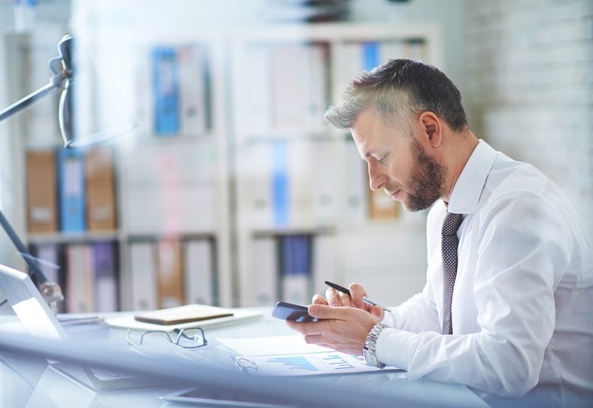 businessman texting in his office