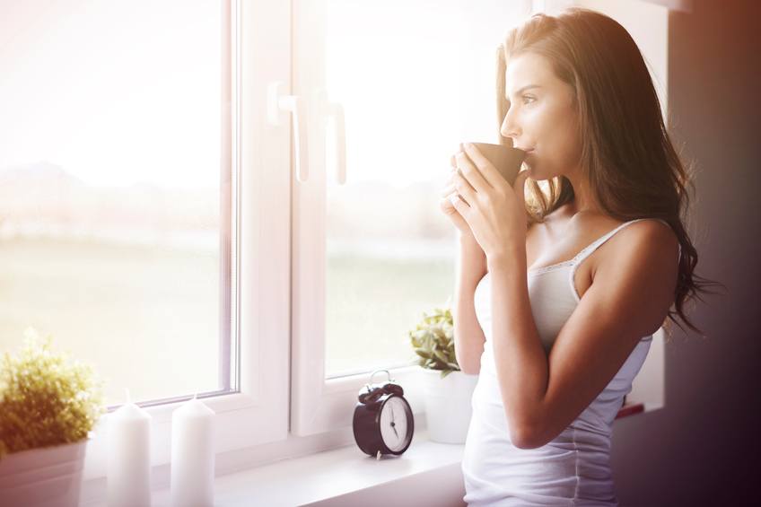 Young woman drinking coffee in the morning