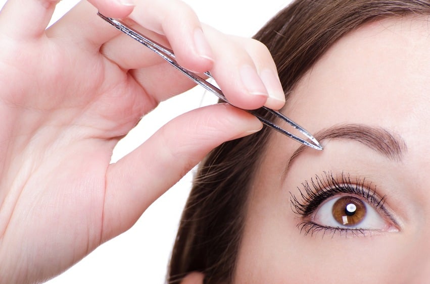 Woman Tweezing Her Eyebrows