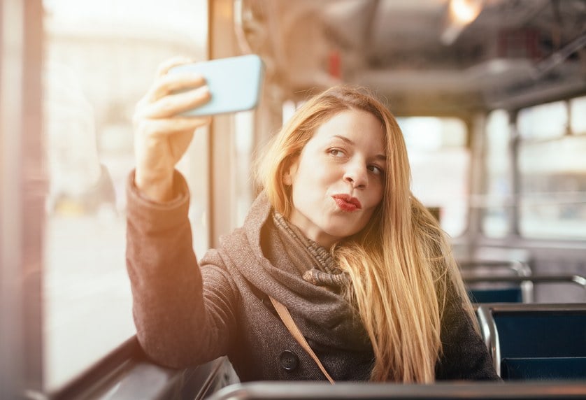 beautiful girl posing in the train with phone