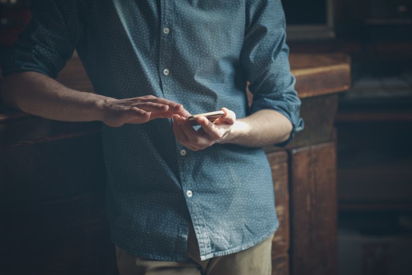 Hipster using a touch screen smart phone hands close up