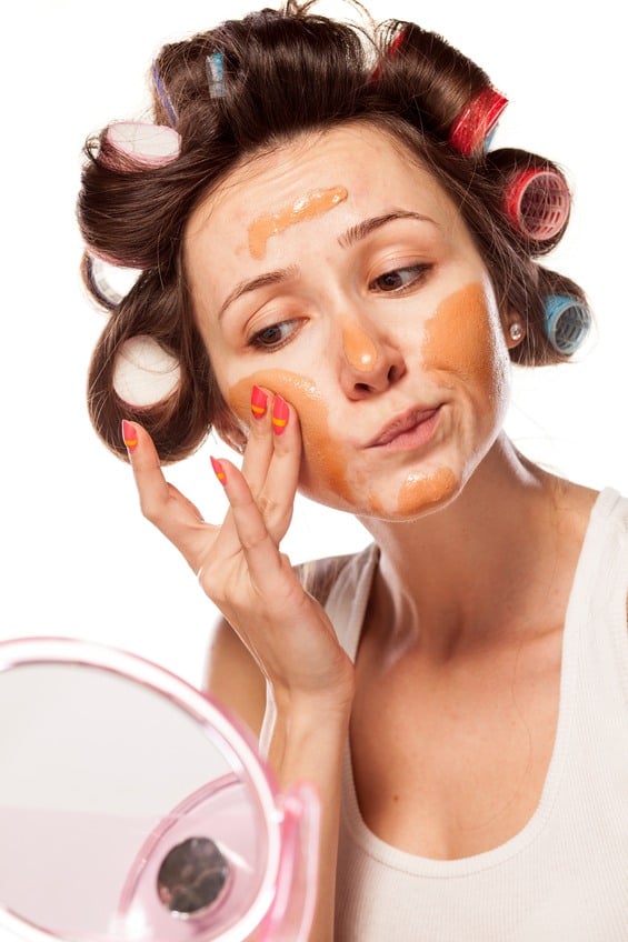 woman applying wrong liquid foundation on her face